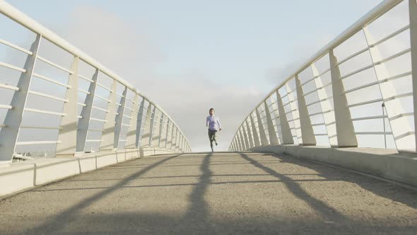 Front view of woman wearing hijab running