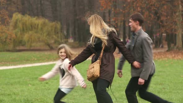 Parents playing with daughter in nature