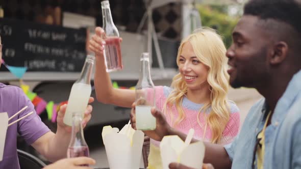 Friends Clinking Bottles of Drinks at Food Truck 