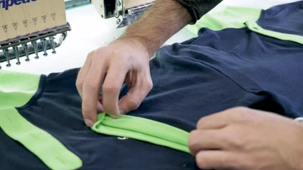 Close Up of Man Hand in a Sewing Factory Checking T-shirts