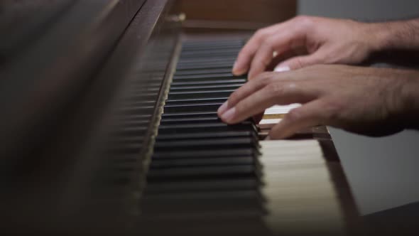 Man's Hands Playing the Piano