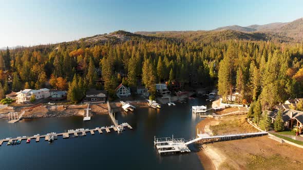 Aerial shot of homes on a beautiful lake during golden hour.