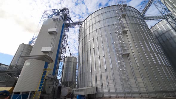 Grain elevators outdoors. Aluminum containers for storing grain. Agribusiness.