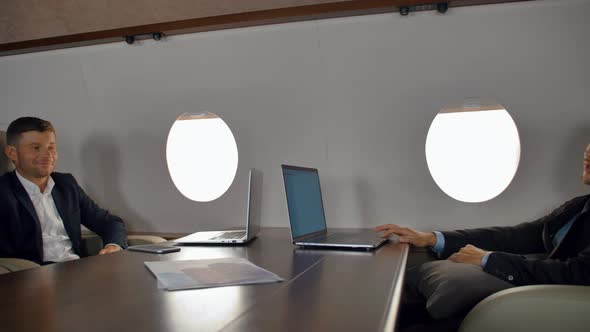 Businesspeople Have Deal Discussion Inside of Luxury Jet