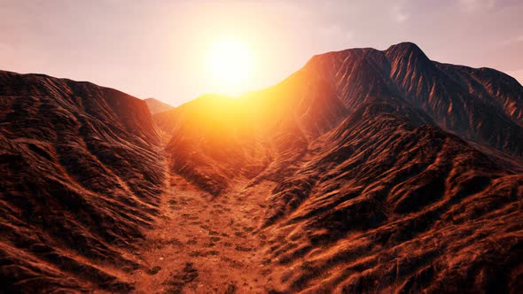 Sun Rays Over Mountains in a Valley