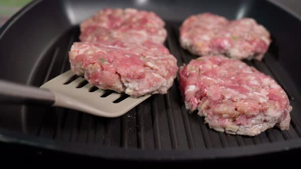 Cooking Minced Meat for Hamburgers on a Grill Pan