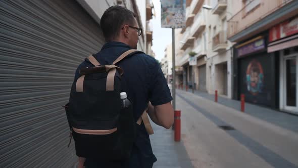 Tourist Enjoying Quiet Walk in City.