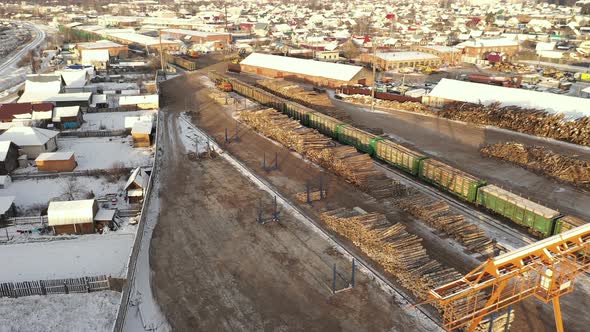 Freight Train Near a Woodworking Factory, Woodworking Factory Aerial View. A Logging Train at