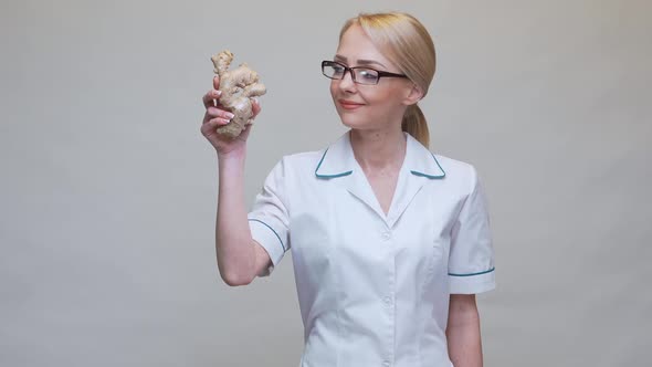 Nutritionist Doctor Healthy Lifestyle Concept - Holding Ginger Root and Measuring Tape