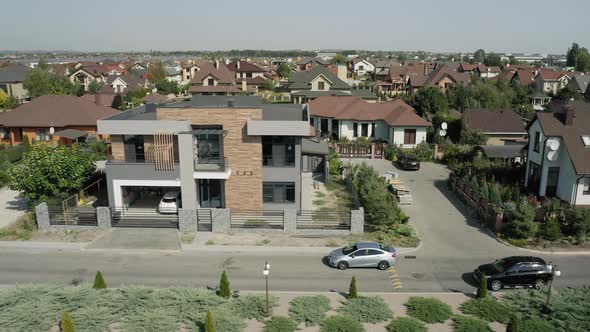 Establishing Shot of Cottage Township with Solar Photovoltaic Panels Arrays on the Roofs