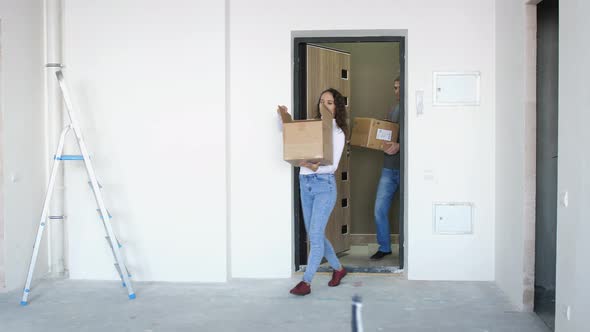 A Young Attractive Couple Moving Into a New Home