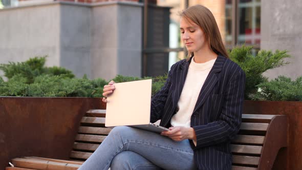 Businesswoman Leaving after Sitting on Bench and working on Laptop