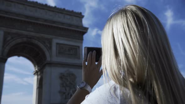 Woman Picturing Arc De Triopmhe in Sunlight