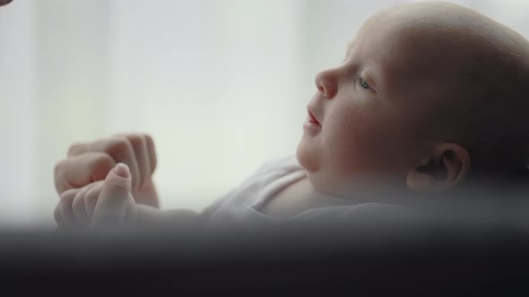 Close Up of Little Newborn Boy Smiling to His Mother