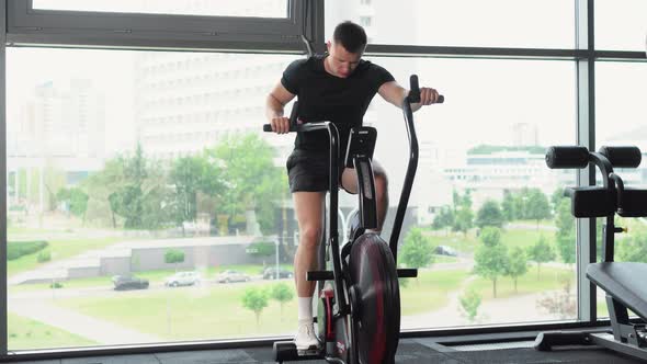 Muscular Man is Engaged in the Gym