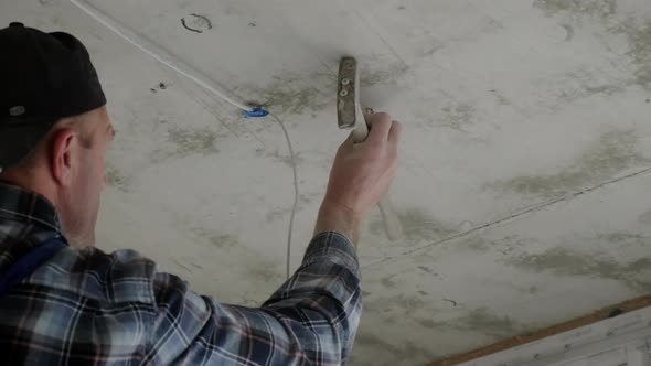 The Worker Installs the Mounting for the LED Lamp Which Will Be Placed on the Suspended Ceiling