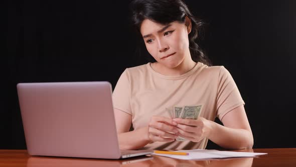 Asian woman paying her bills