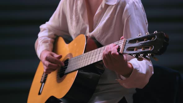 Girl Playing Guitar at Dark Studio