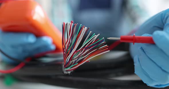 Digital Multimeter Testing Electrical Wires By an Electrician