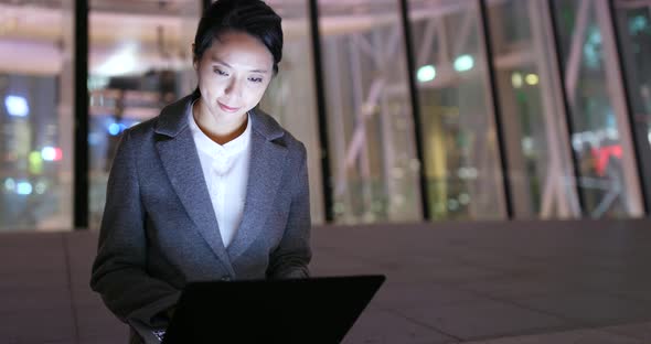 Business woman use of laptop computer at night