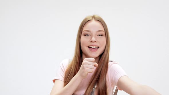 Young Beautiful Girl Dancing Smiling Singing Over White Background