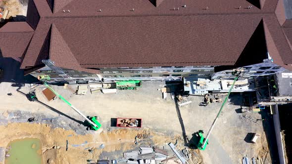 Aerial camera looking straight down and then backing away and tilting up to reveal a building under