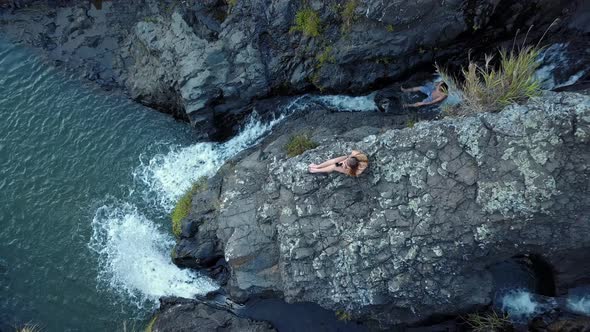 Woman Sitting On The Rocky Cliff Of Bokong Falls In Sagada