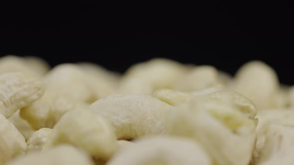 Macro Shot Handful of Fresh Cashews Rotate on a Black Background