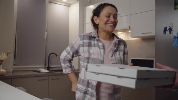 Adult Woman Paying Cash for Pizza to Delivery Guy Indoors