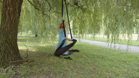 Concentrated Young Girl in Blue Dress Shows Her Skills