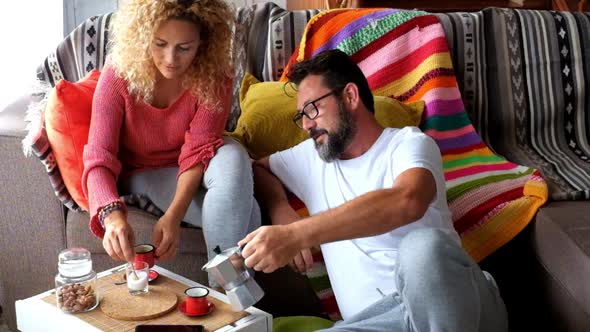 Happy adult caucasian couple at home enjoy breakfast together