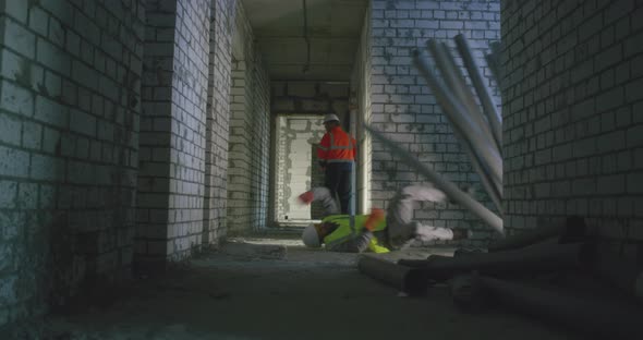Brick and Pipes Falling on Builder on Construction Site