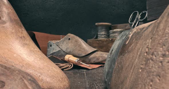 Cobbler workshop with tools, leather and strap. Vintage shoemaker workshop.