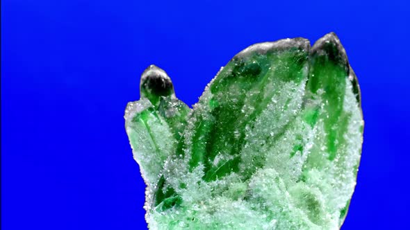 Raw Emerald and Gemstone Rough Rock Crystal on Blue Background