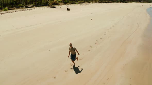 Man Jogging on the Beach in Summer