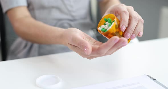 Woman Pours Whitegreen Pills From Jar Into Hand  Movie