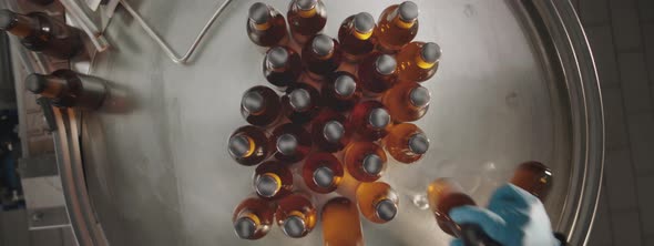 Full beer bottles rotating on a conveyor