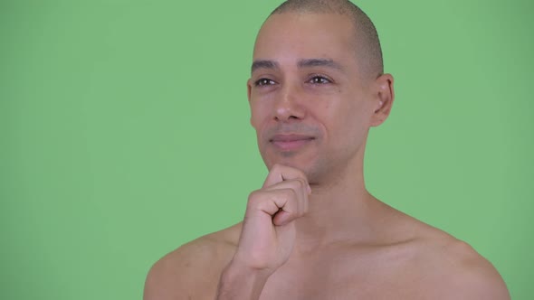 Face of Happy Bald Multi Ethnic Shirtless Man Thinking and Looking Up