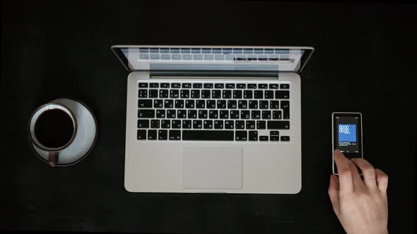 Directly Above Black Table a Man Working on a Laptop With a Cup of Coffee