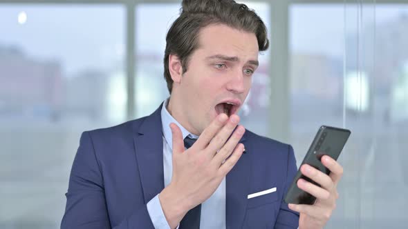 Portrait of Young Businessman Reacting To Failure on Smartphone 