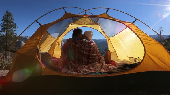 Сouple in Love Sit in an Open Tent, Wrapped in a Blanket and Admiring the Nature of Yosemite Park