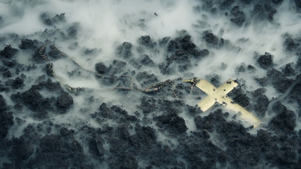 Smoke Clears Revealing Crucifix On The Ground