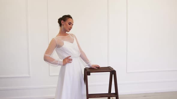 The Ideal Model Bride in a White Dress Poses for the Photographer