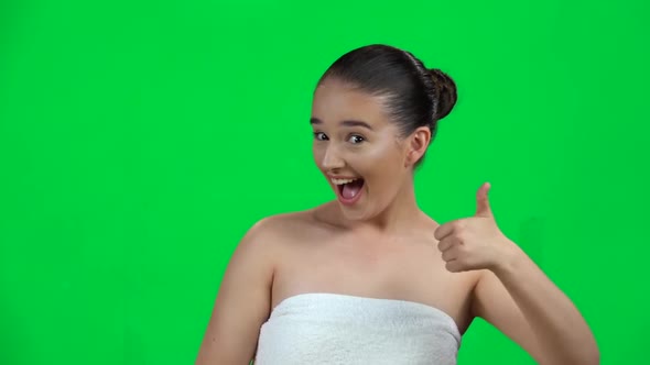 Young Cheerful Woman Showing Thumbs Up, Gesture Like, Isolated on Green Screen at Studio