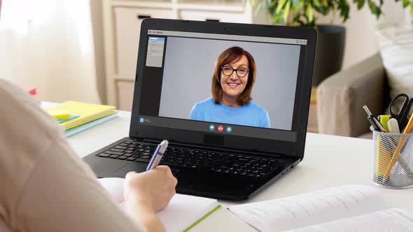 Student Woman with Laptop Watching Video at Home