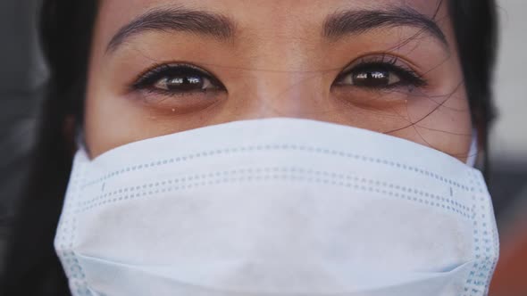 Woman wearing medical coronavirus mask looking at camera