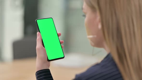 Rear View of Businesswoman Holding Smartphone with Chroma Screen