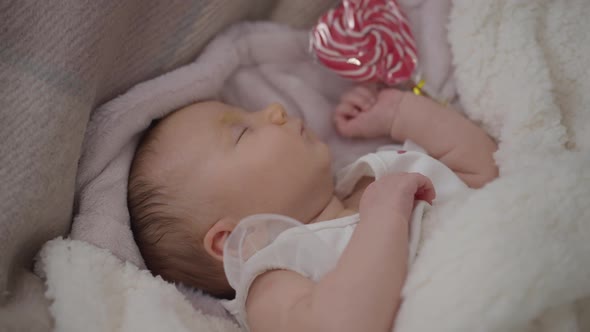 Calm Baby Girl Napping in Comfortable Bed at Home Indoors Top View