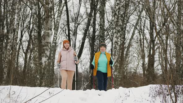 Happy Women Practice Nordic Walking in Winter