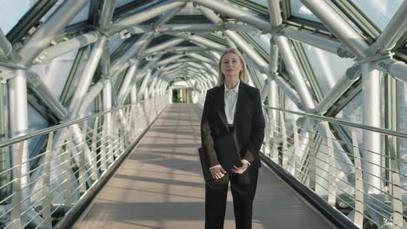 Successful Middle-Aged Business Woman Standing At Glass Bridge